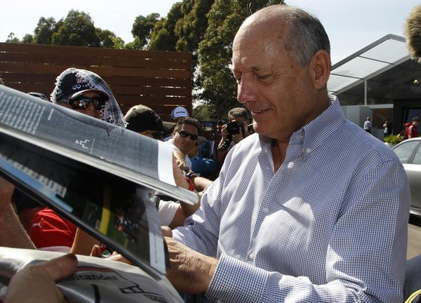 Chairman and CEO of McLaren Formula One team Dennis signs autographs at the first practice session of the Australian F1 Grand Prix in Melbourne