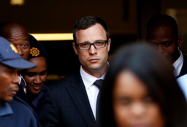 Paralympic track star Oscar Pistorius leaves after listening to the closing arguments in his murder trial at the high court in Pretoria