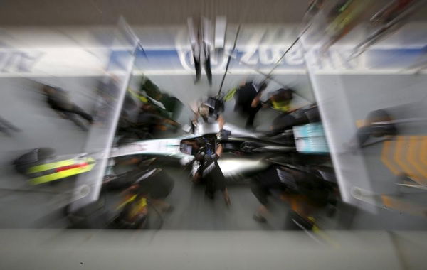 Team members work on the Mercedes Formula One car of Hamilton of Britain in pit lane ahead of the first practice session of the Singapore F1 Grand Prix