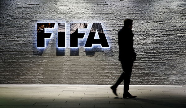 A journalist walks in front of FIFA&#8217;s headquarters in Zurich