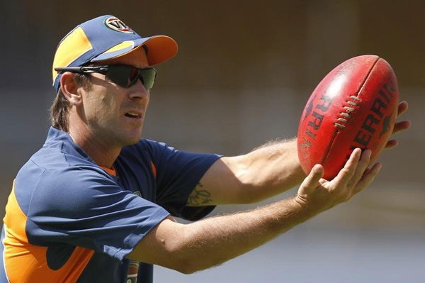 Australia&#8217;s batting consultant Langer plays with a rugby ball during a cricket practice session in Ahmedabad