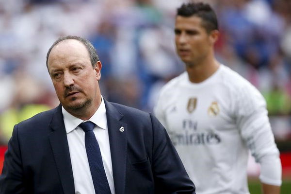 Real Madrid&#8217;s coach Benitez stands as player Ronaldo walks past behind him before their Spanish First Division soccer match against Malaga in Madrid