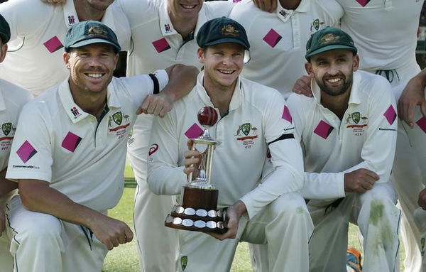 Australia&#8217;s test cricket captain Steve Smith holds the Frank Worrell trophy among team mates David Warner and Nathan Lyon after their third cricket test against the West Indies at the SCG in Sydney