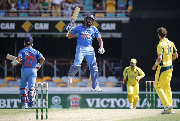 India&#8217;s Rohit Sharma (C) jumps as he celebrates reaching his century during the second One Day International cricket match against Australia in Brisbane