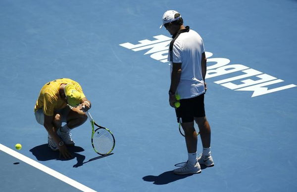 Spain&#8217;s Nadal leans on his racquet during a practice session at Melbourne Park, Australia