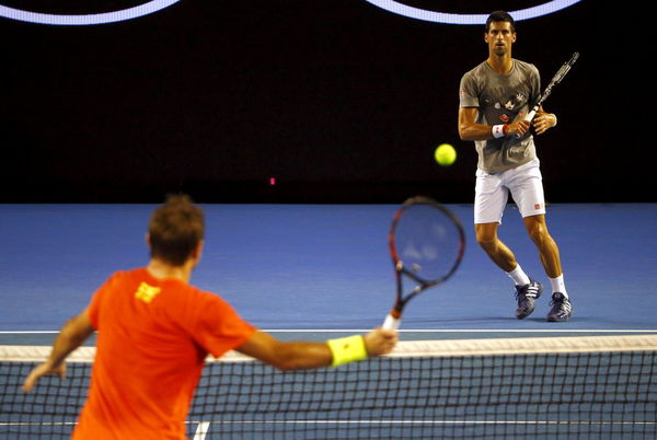 Serbia&#8217;s Novak Djokovic trains with Switzerland&#8217;s Stan Wawrinka during a practice session at Melbourne Park, Australia