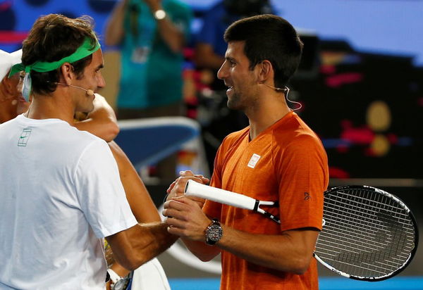 Serbia&#8217;s Djokovic and Switzerland&#8217;s Federer shake hands during Kids Tennis Day at Melbourne Park, Australia