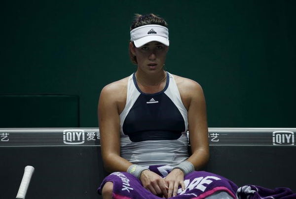 Garbine Muguruza of Spain looks on from her bench during her women&#8217;s singles semi-finals tennis match of the WTA Finals against Agnieszka Radwanska of Poland at the Singapore Indoor Stadium