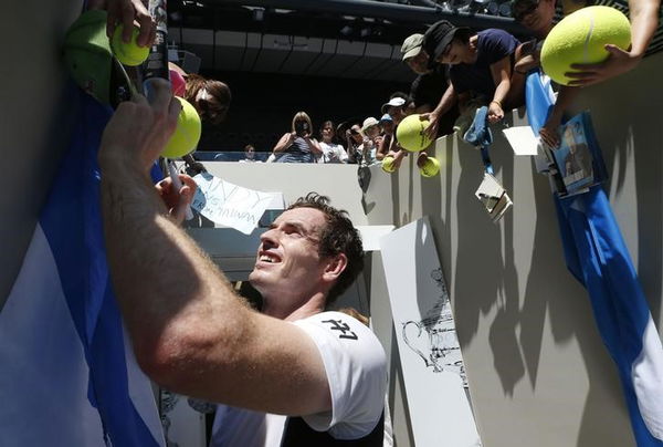 Britain&#8217;s Murray signs autographs after winning his first round match against Germany&#8217;s Zverev at the Australian Open tennis tournament at Melbourne Park, Australia