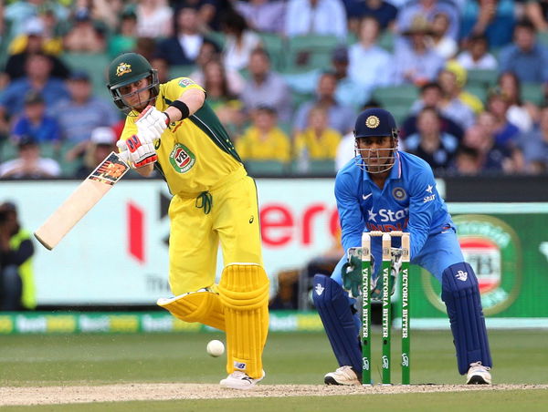 Australia&#8217;s Steven Smith bats as India&#8217;s Mahendra Singh Dhoni watches during their One Day cricket match at the Melbourne Cricket Ground