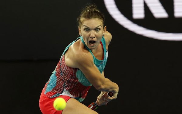 Romania&#8217;s Halep prepares to hit a shot during her first round match against China&#8217;s Zhang at the Australian Open tennis tournament at Melbourne Park, Australia