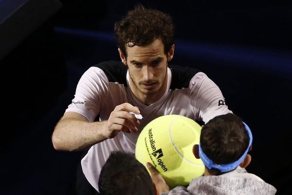 Britain&#8217;s Murray signs autographs after winning his semi-final match against Canada&#8217;s Raonic at the Australian Open tennis tournament at Melbourne Park