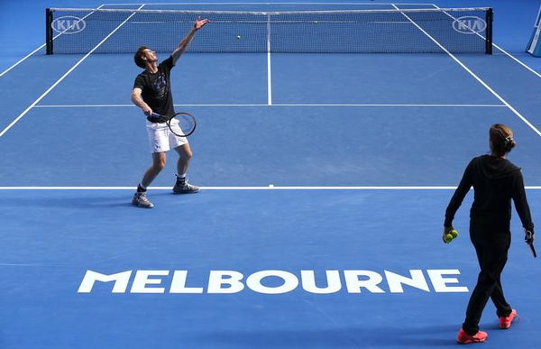 Britain&#8217;s Murray serves as his coach Amelie Mauresmo watches during a practice session on the eve of his final match against Serbia&#8217;s Djokovic, at the Australian Open tennis tournament at Melbourne Park