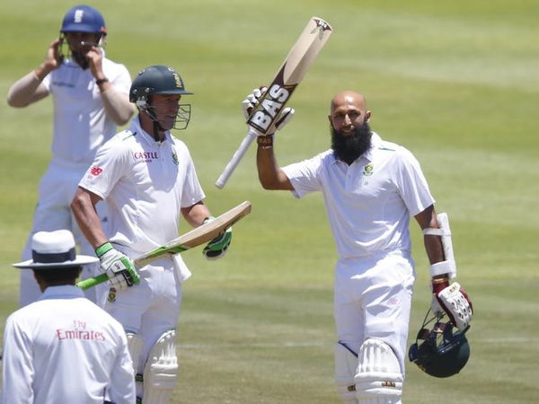 South Africa&#8217;s Amla celebrates scoring a century with de Villiers during the second cricket test match against England in Cape Town