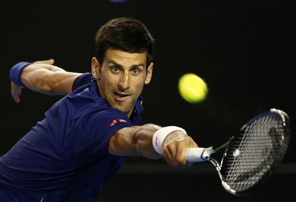 Serbia&#8217;s Djokovic stretches to hit a shot during his second round match against France&#8217;s Halys at the Australian Open tennis tournament at Melbourne Park