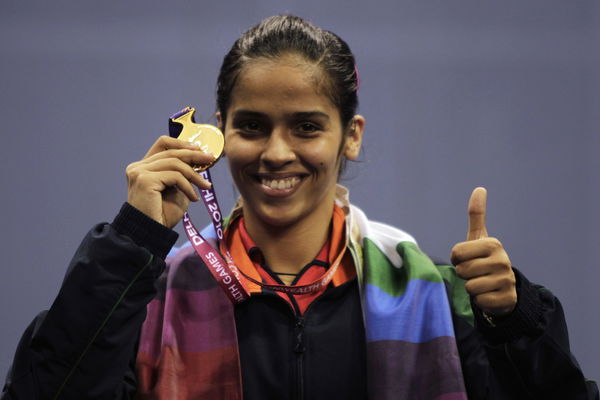 India&#8217;s Nehwal poses with her gold medal after winning the women&#8217;s singles badminton finals at the Commonwealth Games in New Delhi