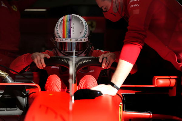 F1- Sebastian Vettel wearing his helmet with visors attached to it