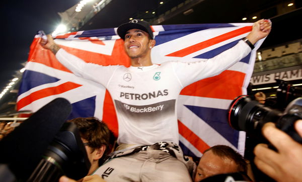 FILE PHOTO: Mercedes Formula One driver Lewis Hamilton of Britain celebrates with his team after winning the Abu Dhabi F1 Grand Prix at the Yas Marina circuit in Abu Dhabi