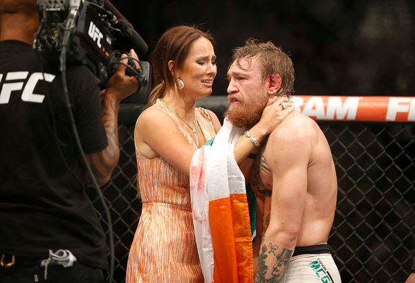 UFC champion Conor McGregor poses with long-term girlfriend Dee as he  returns home