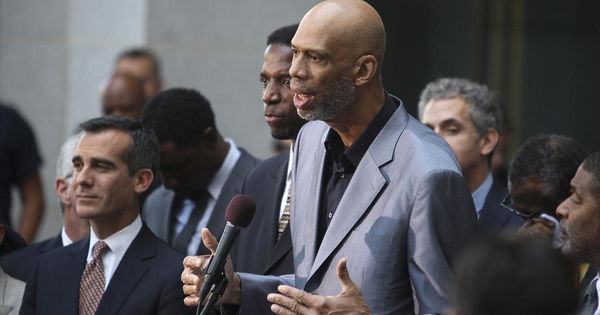 Retired basketball star Abdul-Jabbar speaks as Los Angeles Mayor Garcetti stands by at a news conference outside City Hall