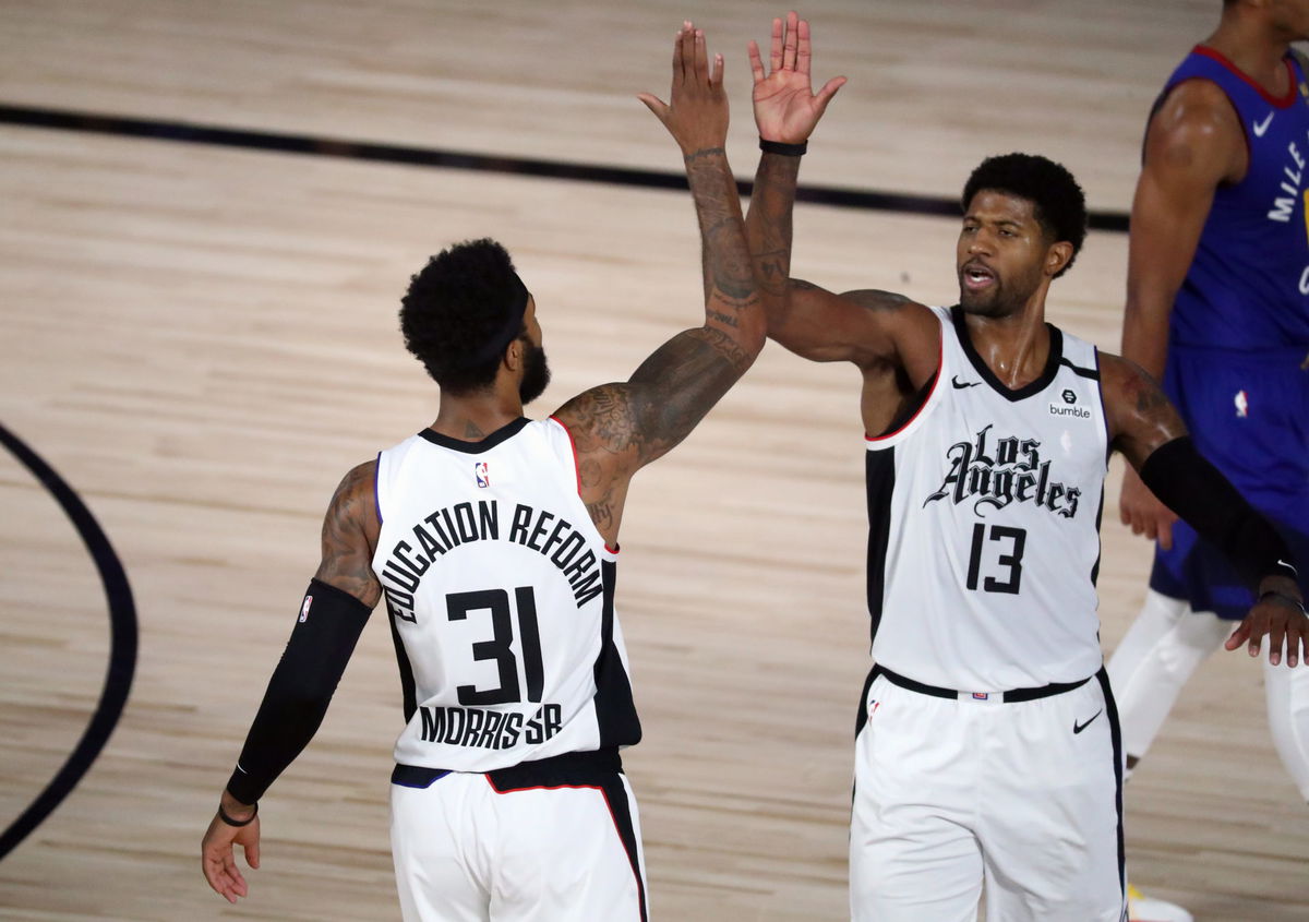 LA Clippers forward Paul George celebrates with Marcus Morris Sr. during the first of Gae 5 against the Denver Nuggets