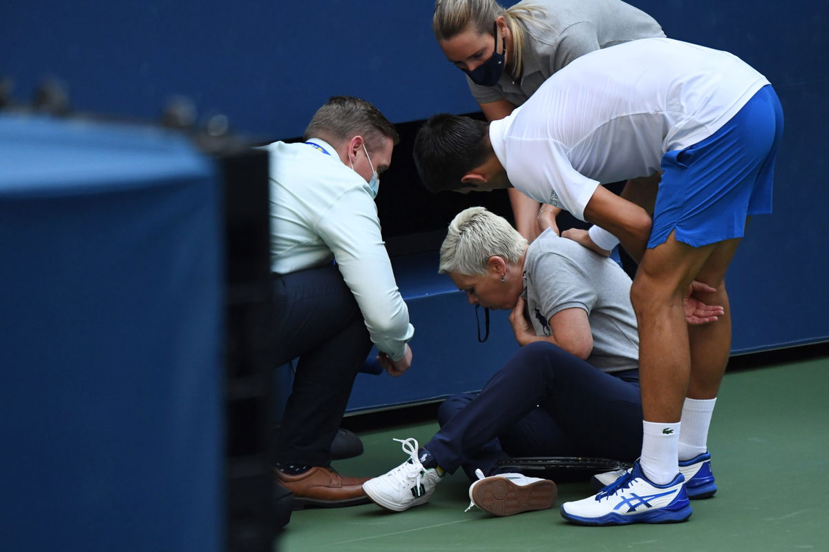 Novak Djokovic attends to check on the lineswoman after her accidentally hit her with the ball at the 2020 US Open