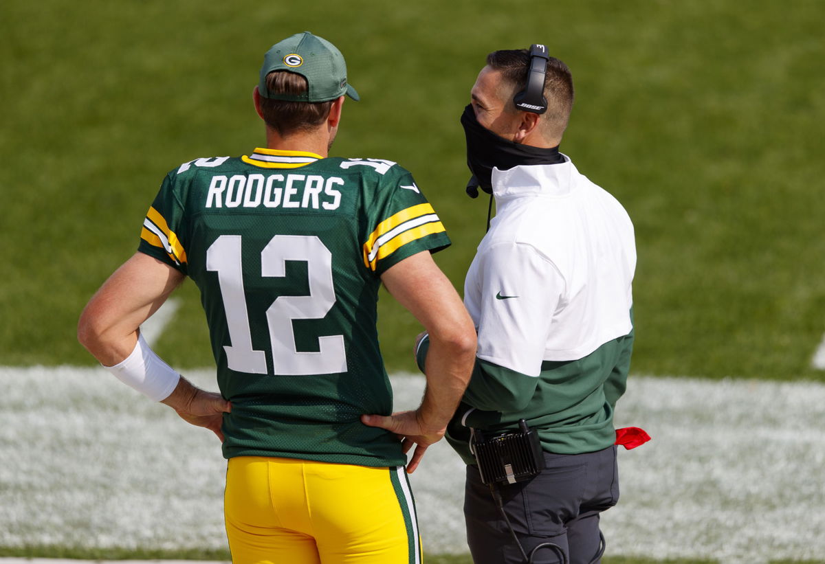 Green Bay Packers quarterback Aaron Rodgers has a chat with head coach Matt LaFleur.