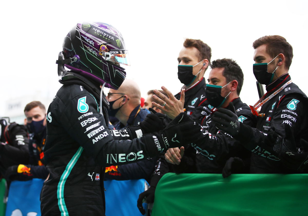 Mercedes driver Lewis Hamilton celebrates with his team winning the Eifel GP