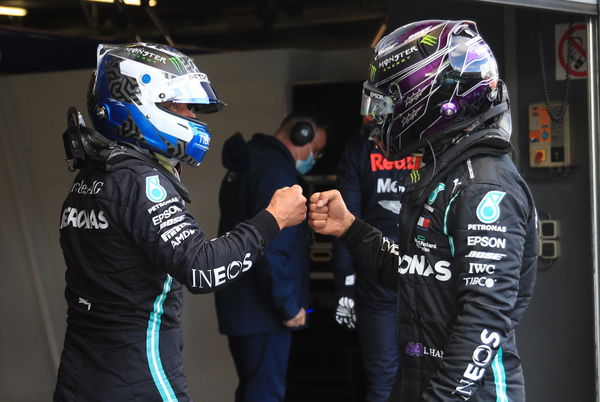 Mercedes duo Lewis Hamilton and Valtteri Bottad fist bump after the latter takes pole at the Nurburgring