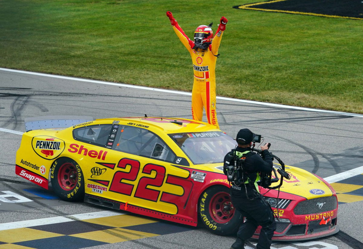 Joey Logano celebrates his win in the NASCAR Cup Series race at Kansas Speedway