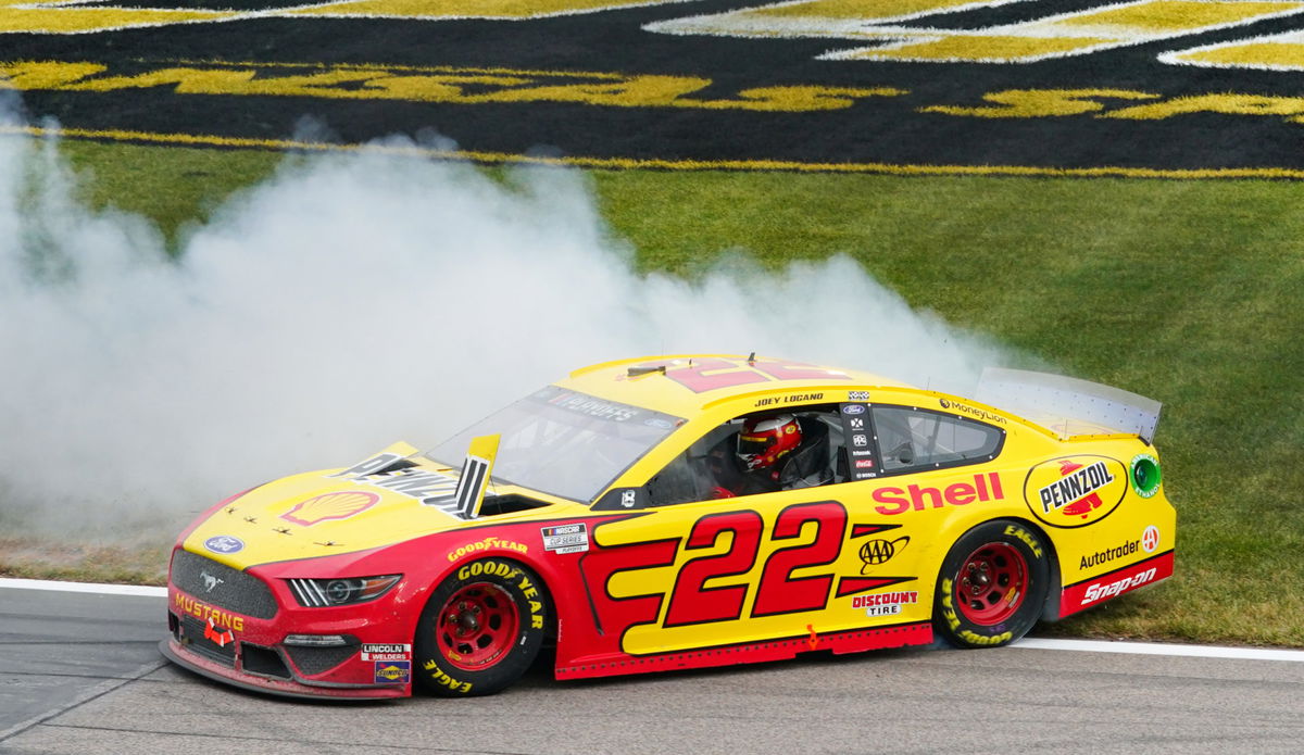 Joey Logano celebrates after winning the NASCAR Cup Series race at Kansas