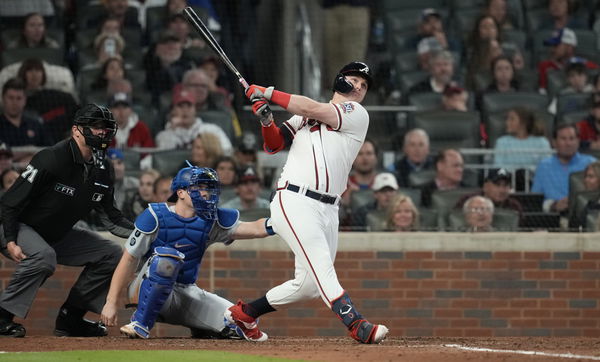 Joc Pederson of the Atlanta Braves puts a batting helmet over his