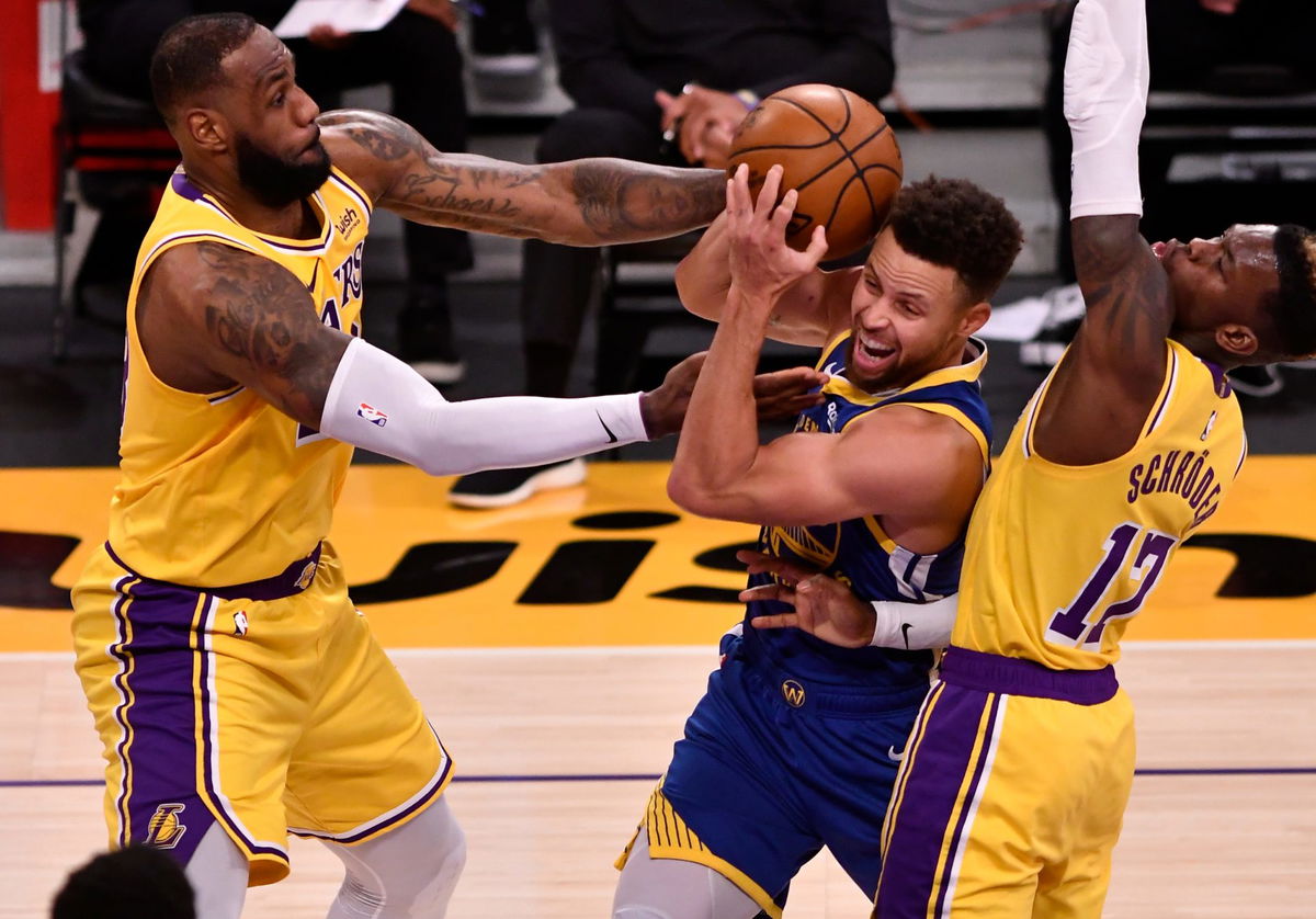 Los Angeles Lakers forward LeBron James fights for the ball with Warriors' Stephen Curry