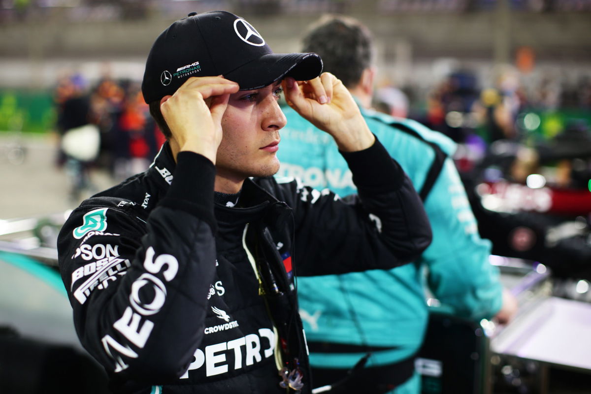 George Russell adjusts his Mercedes cap as he looks on before the Sakhir GP