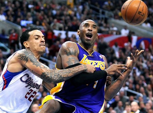 Lakers Kobe Bryant is fouled by Clippers Matt Barnes while driving to the basket at the Staples Cen