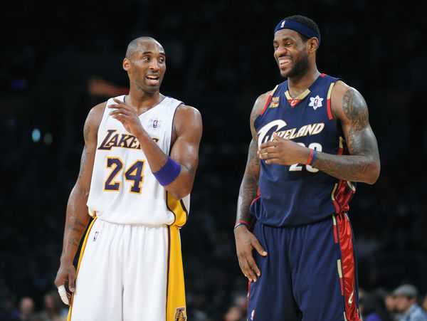 Lakers Kobe Bryant argues with a referee as Cavaliers LeBron James laughs at the Staples Center Fri