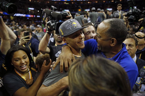 Golden State Warriors&#8217; Stephen Curry celebrates with his father Dell Curry after defeating Cleveland Cavaliers in Game 6 of NBA Finals at Quicken Loans Arena in Cleveland, Ohio, on Tuesday, June 16, 2015.