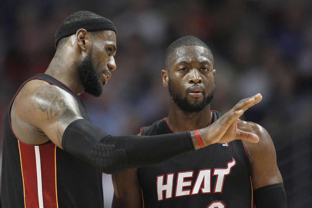 LeBron James (6) talks to Miami Heat shooting guard Dwyane Wade