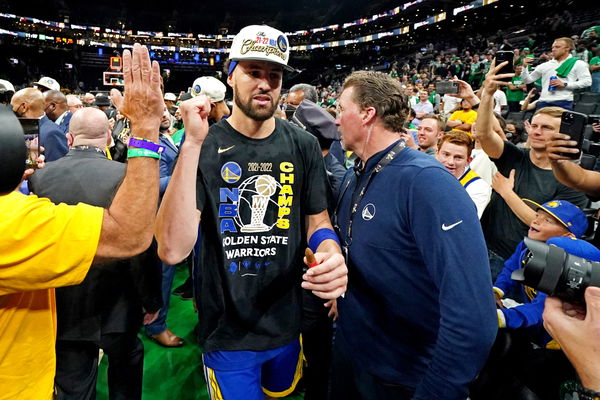 Klay Thompson chugs a beer while cheering his brother on at