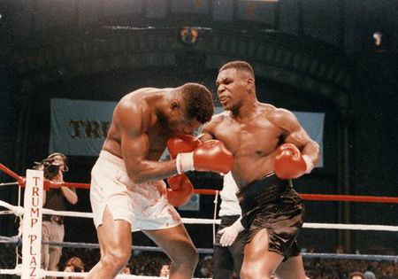 WATCH: Mike Tyson Brutalizes Tyrell Biggs to Unify Heavyweight Titles ...