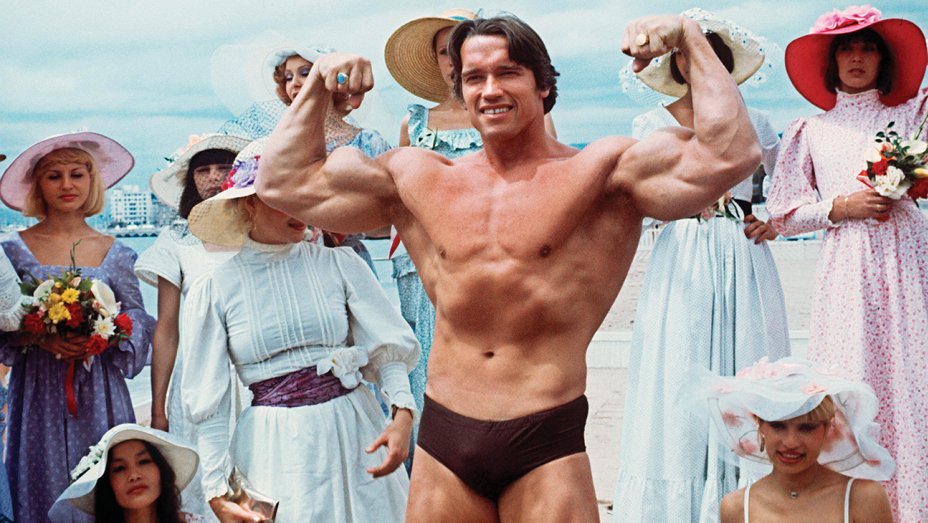 Arnold Schwarzenegger Lifting a Model on His Shoulder As He Showed Off His 24 Inch Biceps Left Models Amazed by His Beast Like Body in an Unearthed Image