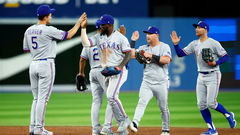 Corey Seager, Brad Miller, Adolis Garcia and Kole Calhoun of the Texas Rangers celebrate the victory following a MLB game against the Toronto Blue Jays
