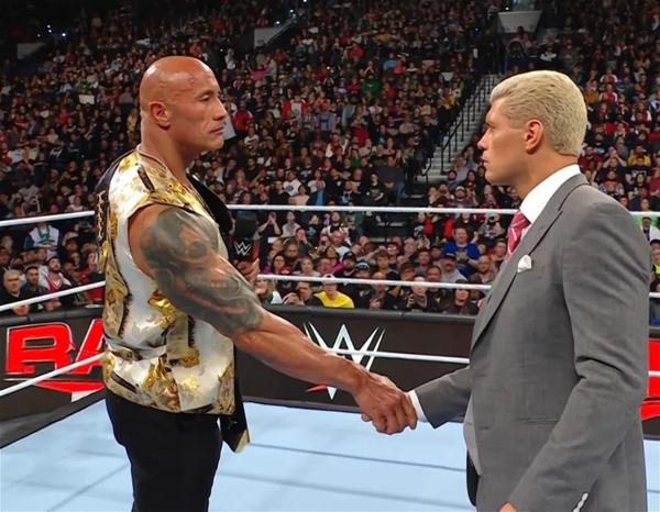 Dwayne johnson giving cody rhodes a Gift on Raw