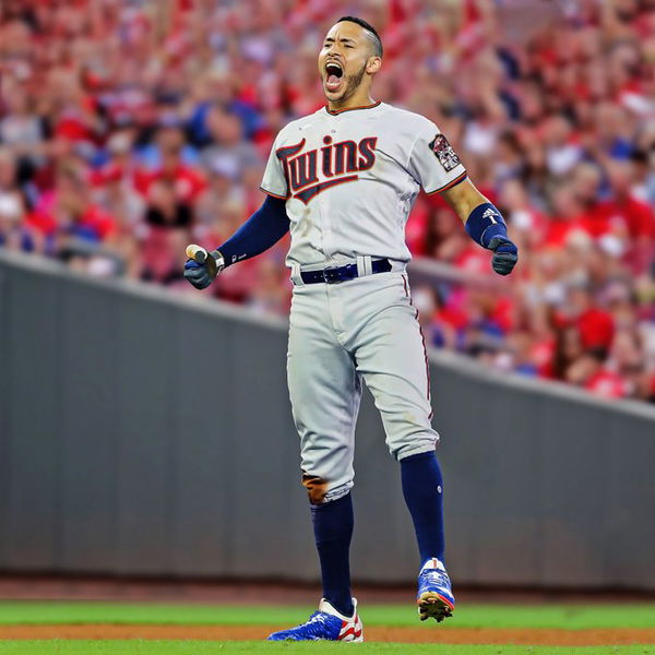 Minnesota Twins' Carlos Correa, left, follows through on a two-run