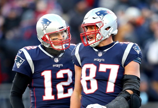 New England Patriots quarterback Tom Brady, top, playfully tackles teammate  Rob Gronkowski after he grabbed and ran with Brady's stolen and recovered  Super Bowl jersey during Boston Red Sox Home Opening Day