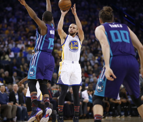 Golden State Warriors&#8217; Stephen Curry (30) scores a three point basket against Charlotte Hornets&#8217; Kemba Walker (15) in the second quarter at Oracle Arena in Oakland, Calif. on Wednesday, Feb. 1, 2017. (Nhat V. Meyer/Bay Area News Group)