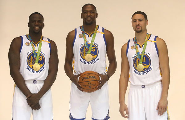 Golden State Warriors players Draymond Green (23), Kevin Durant (35), and Klay Thompson are photographed with their Olympic gold medals during media day on Monday, Sept. 26, 2016, in Oakland, Calif.  (Aric Crabb/Bay Area News Group)