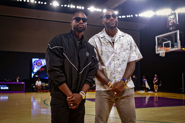 Lebron James and Dwyane Wade attend a Los Angeles Sparks WNBA game