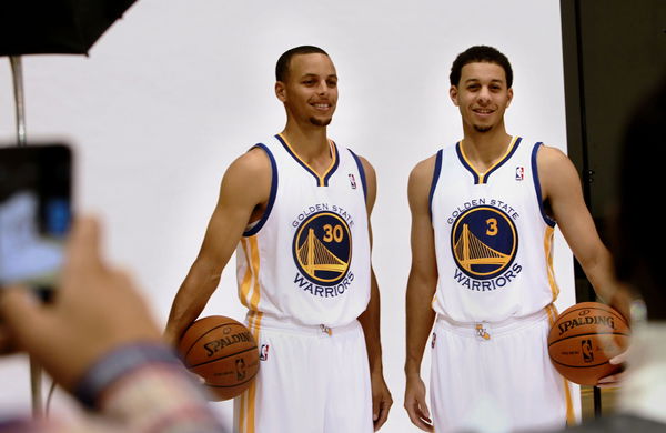 Brothers Stephen, (30) and Seth Curry, (3) pose for photographs as the Golden State Warriors hold a media day at their practice facility in downtown Oakland, Calif. on Friday September 27, 2013.