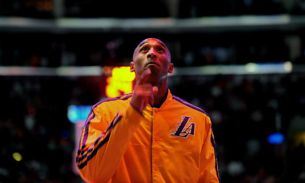 During the National Anthem Lakers Kobe Bryant points to upward honoring Lakers owner Jerry Buss at